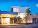 Modern family house exterior by twilight